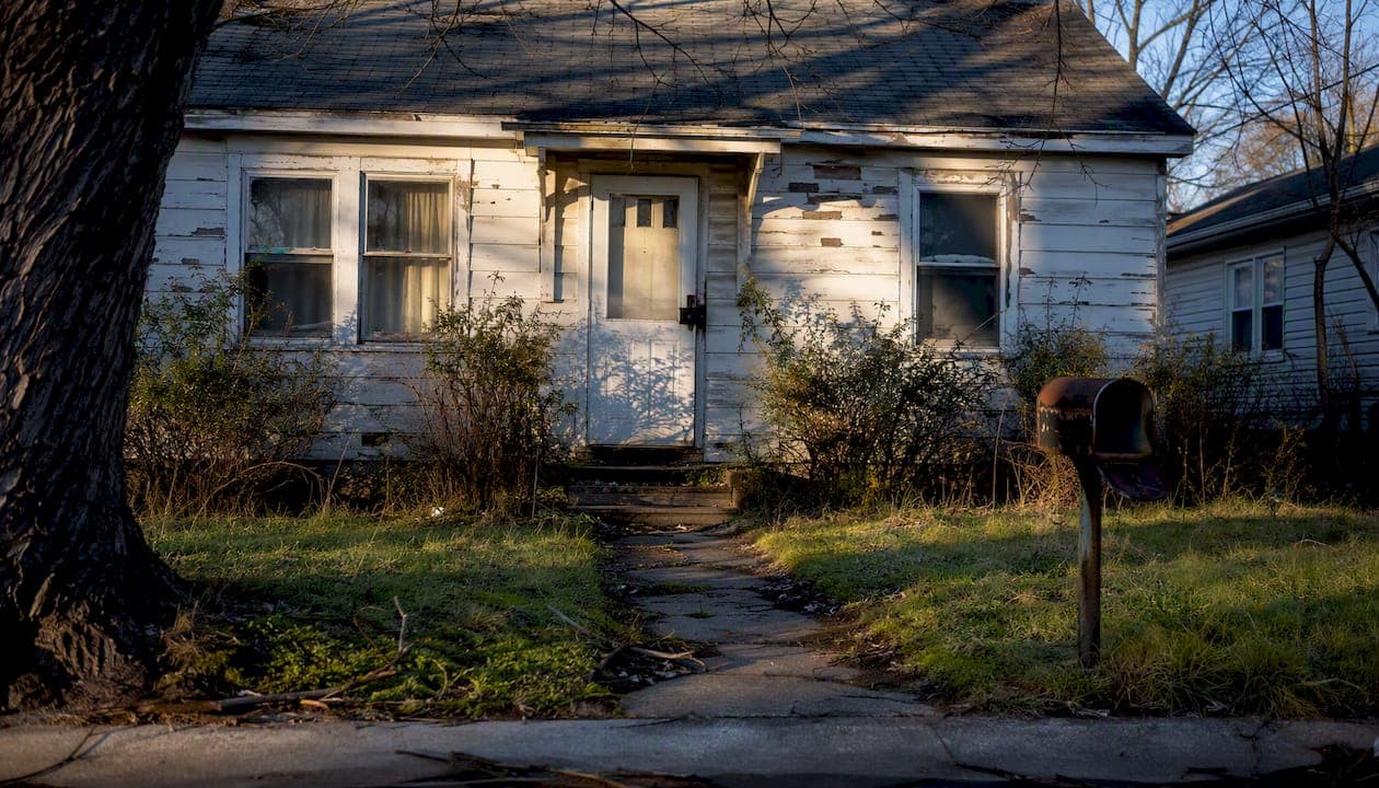 Hands unlocking door of vacant home for fast sale