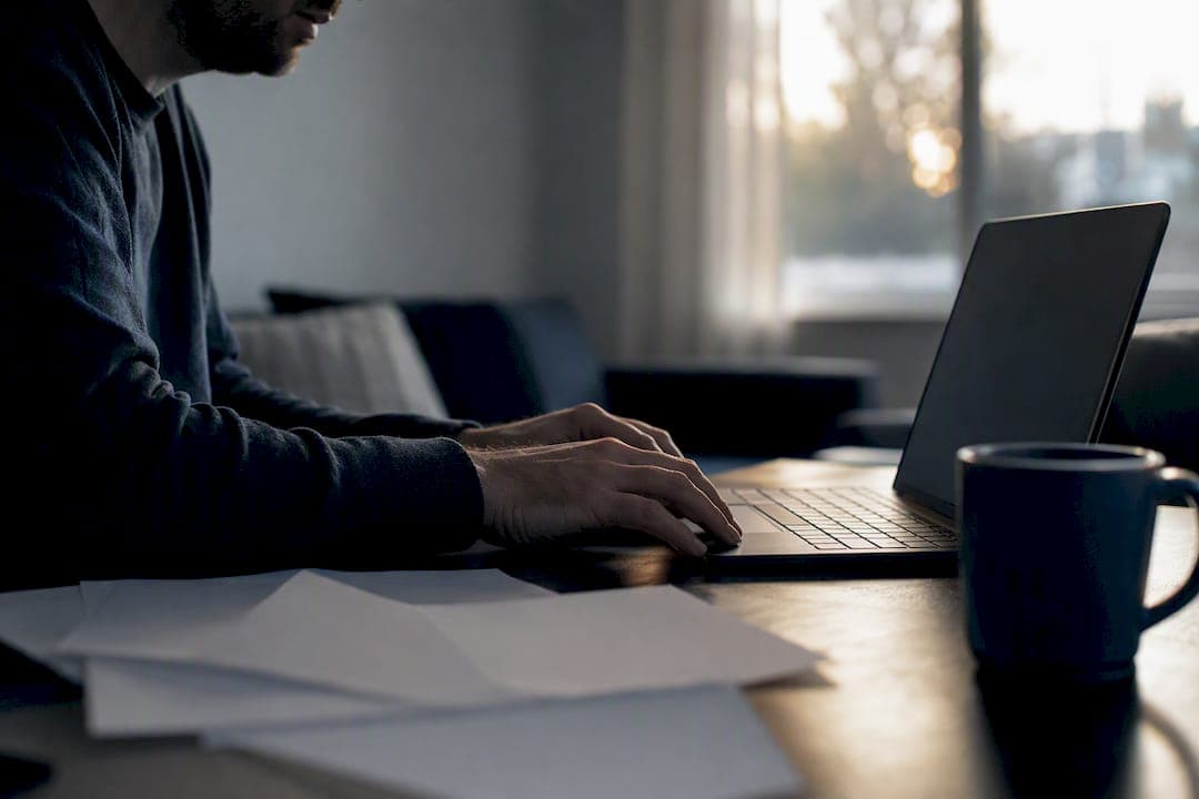 Hands near a dark laptop screen expressing concern